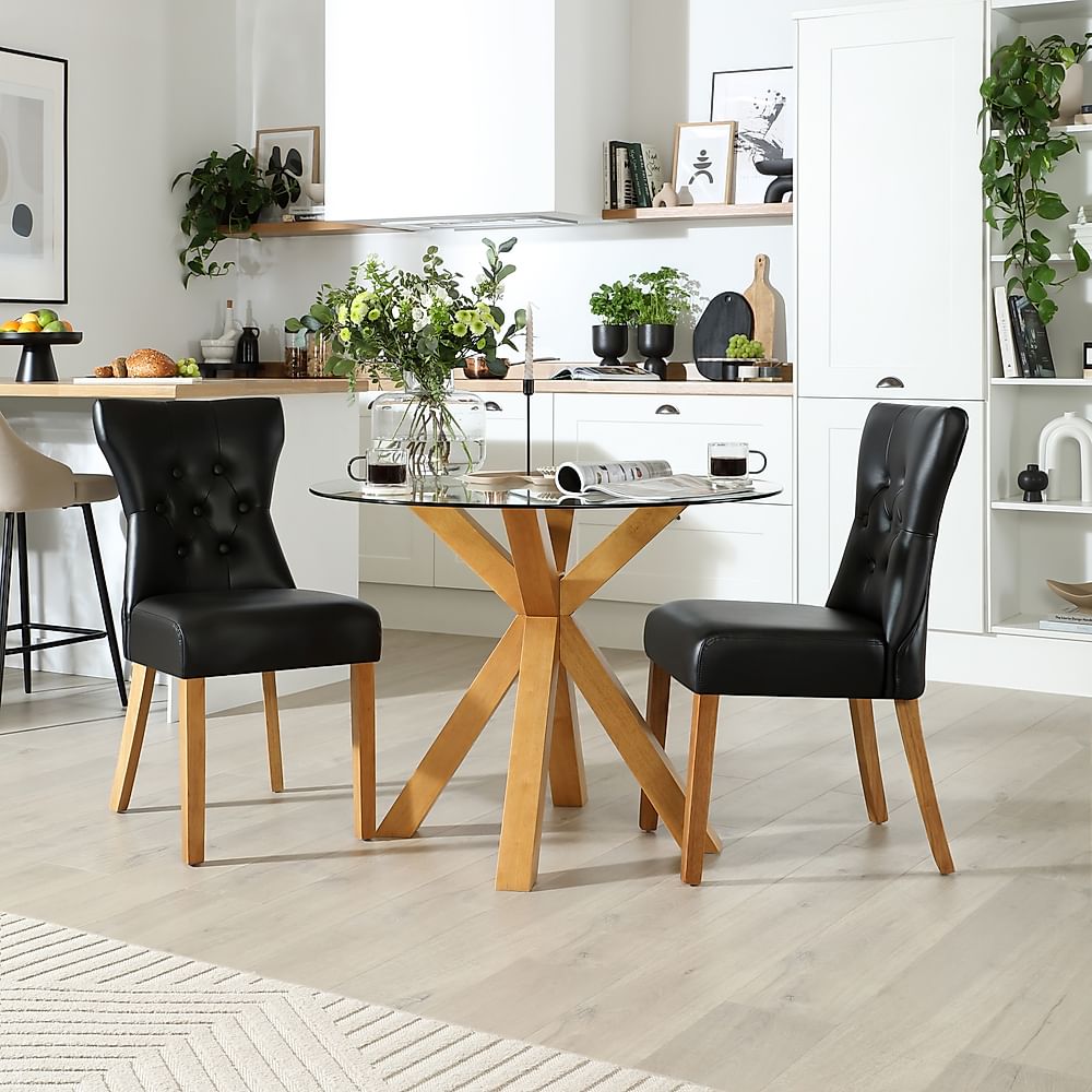 Hatton Round Dining Table & 2 Bewley Chairs, Glass & Natural Oak Finished Solid Hardwood, Black Classic Faux Leather, 100cm