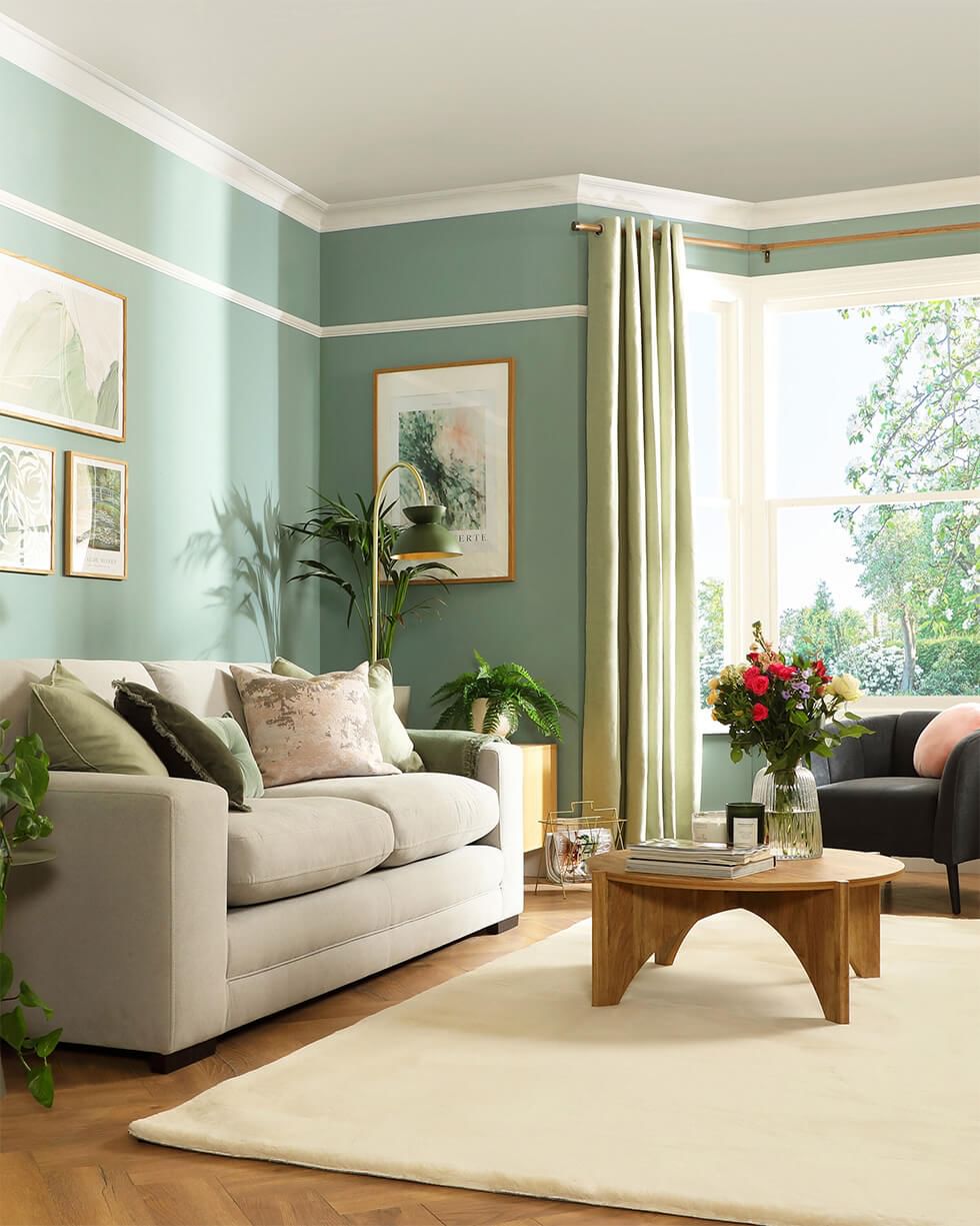 Stylish living room featuring a bay window feature wall in sage green