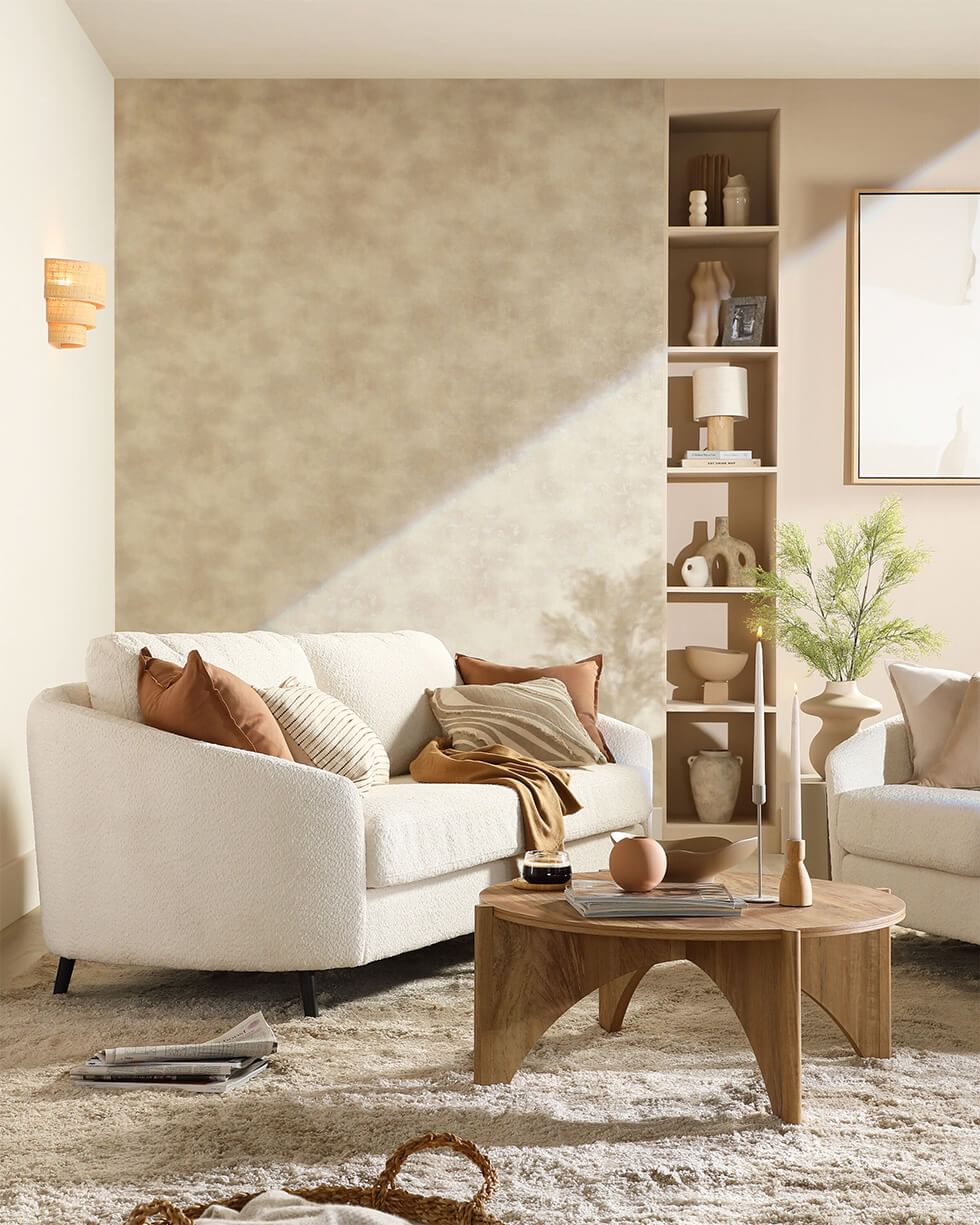 A cream fabric sofa in a neutral contemporary living room