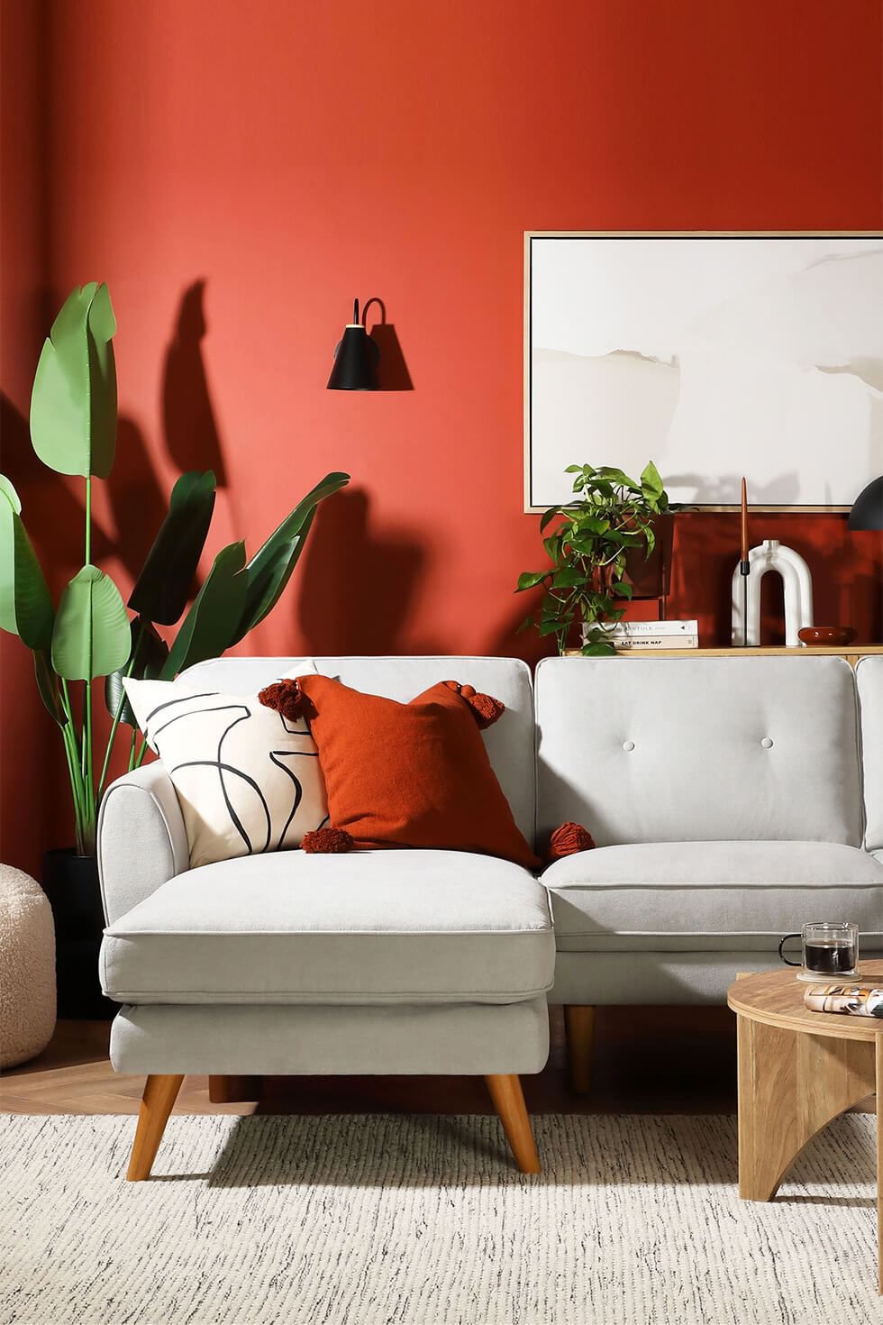 Earth tone living room with terracotta walls and grey sofa