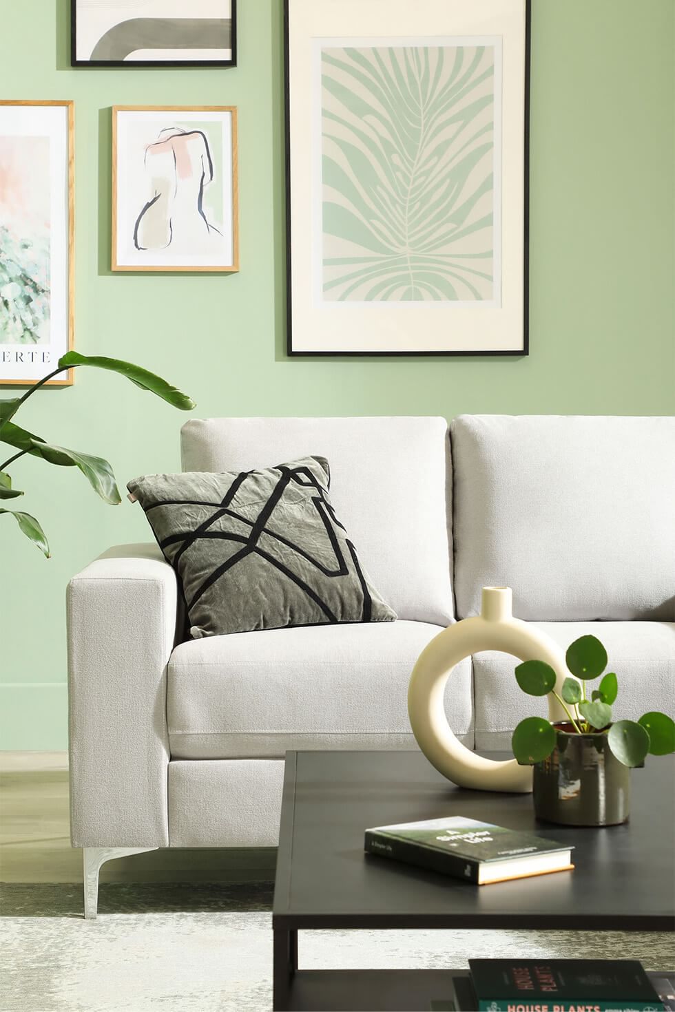 Pastel green living room with modern grey sofa