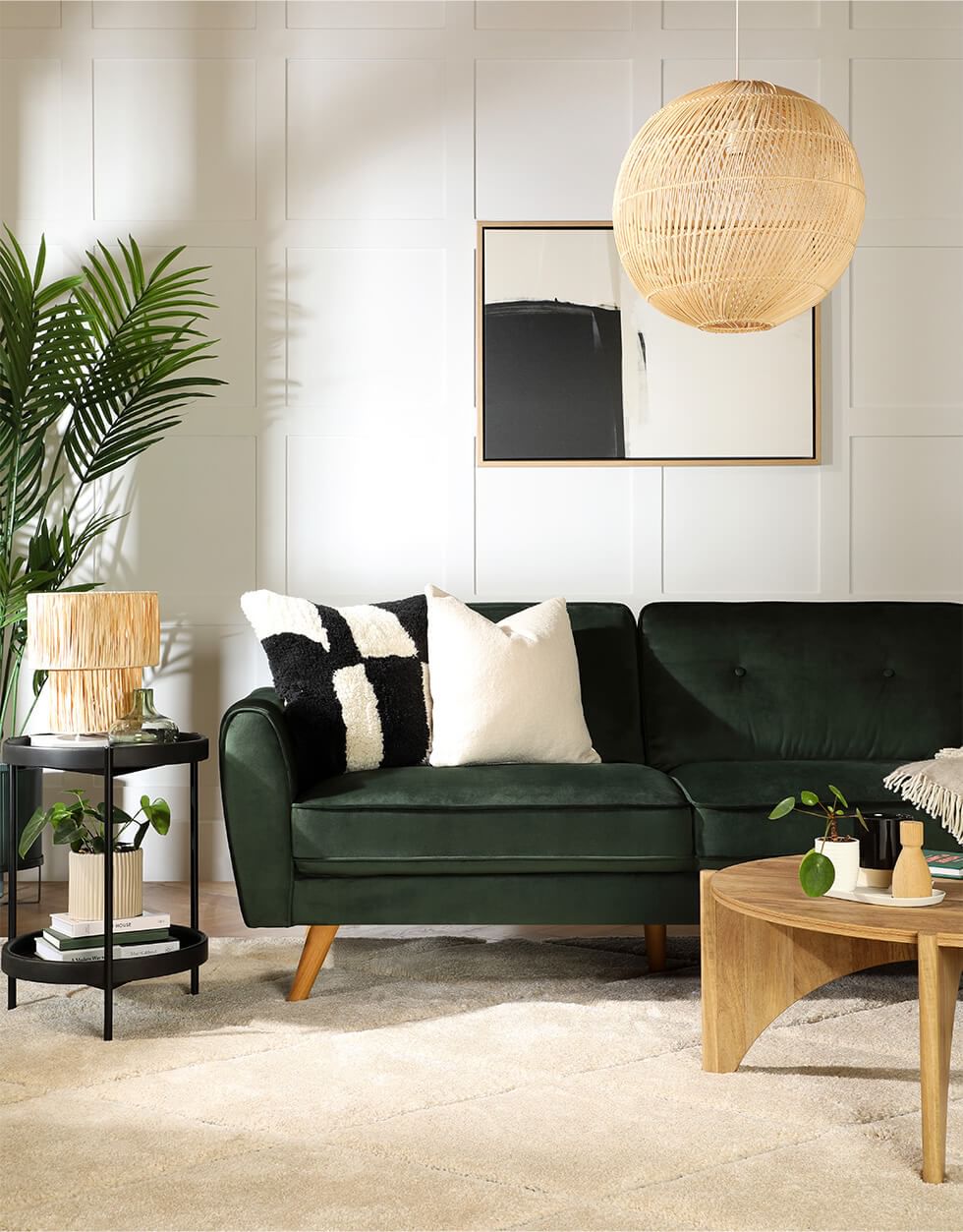 A green living room with boho-inspired decor