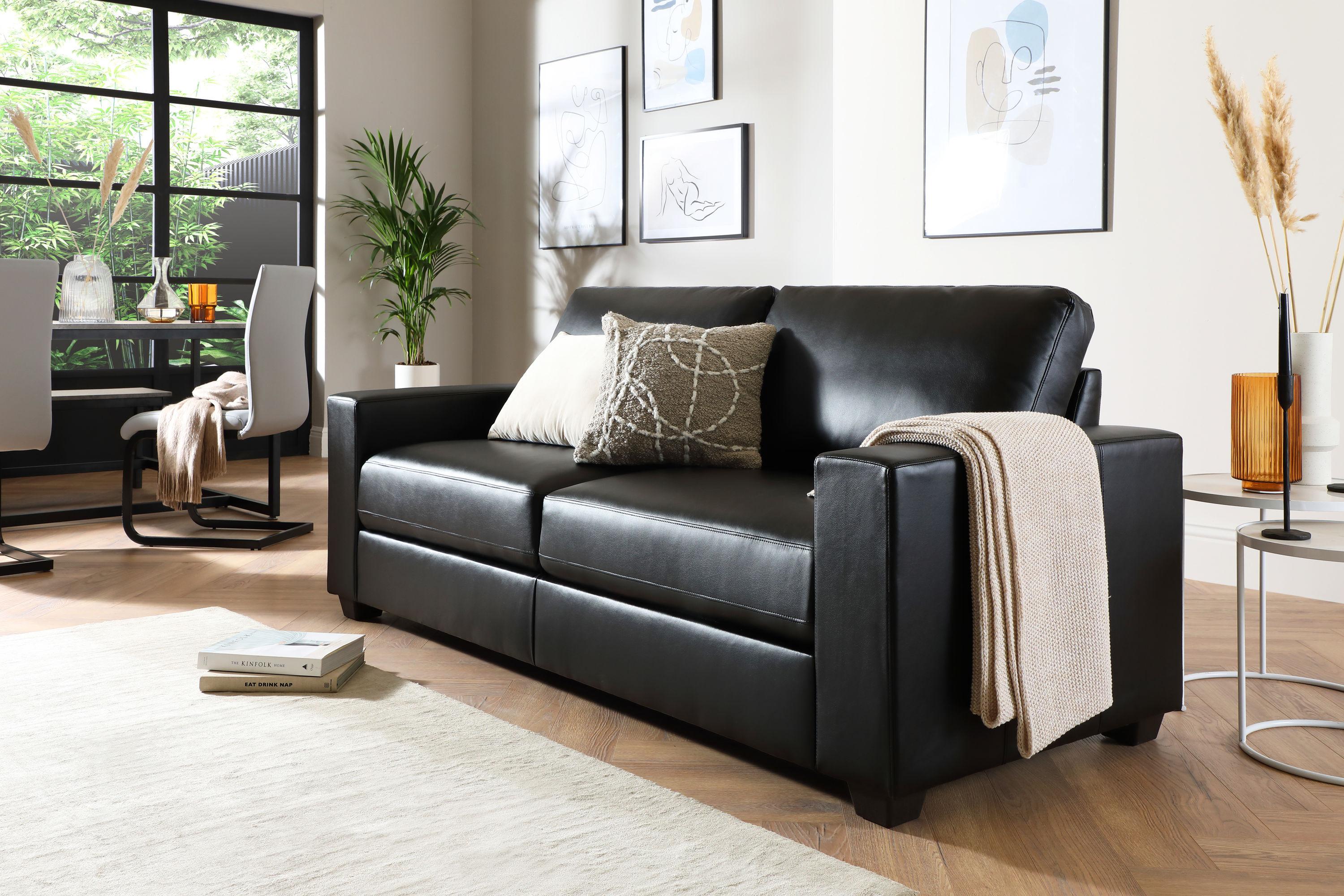 minimalistic living room with black leather sofa