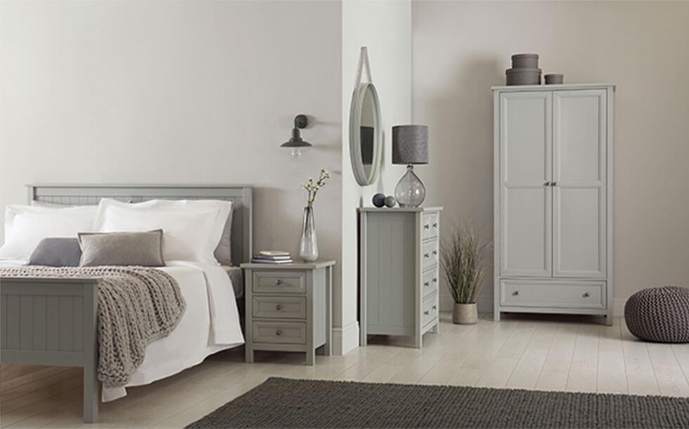 Monochrome grey bedroom with matching cabinets, drawers, and bed frame.