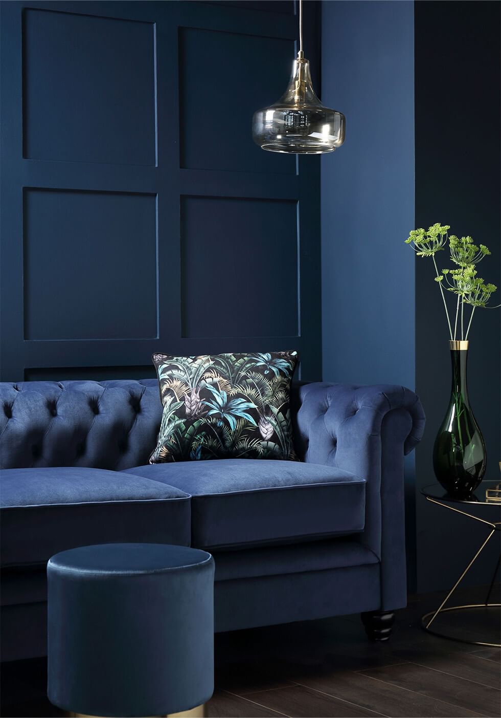 Blue living room with blue sofa, vibrant textures and prints