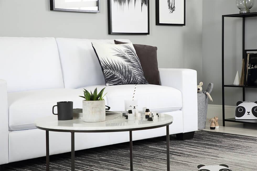 White sofa with black decorative elements..