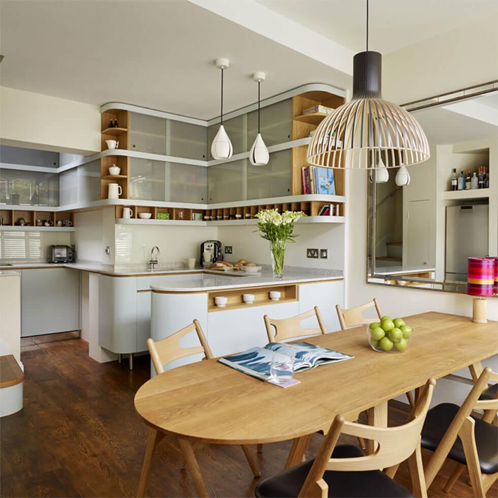 7 Open Plan Kitchen With Rounded Curves Wooden Table And Chairs And Statement Lamp 