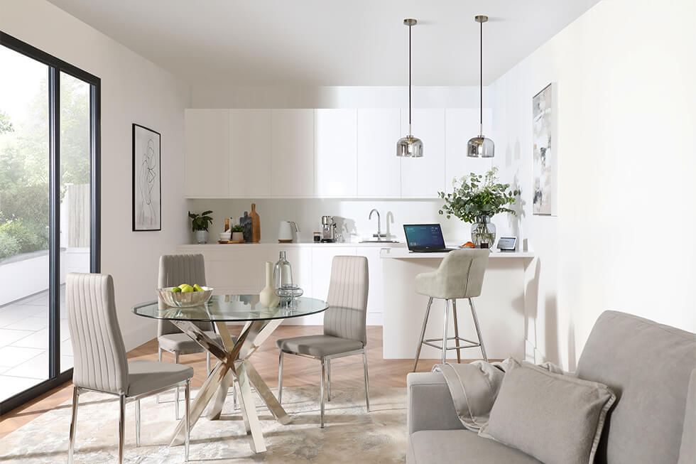 Open plan kitchen with a peninsula, glass dining table, and sofa