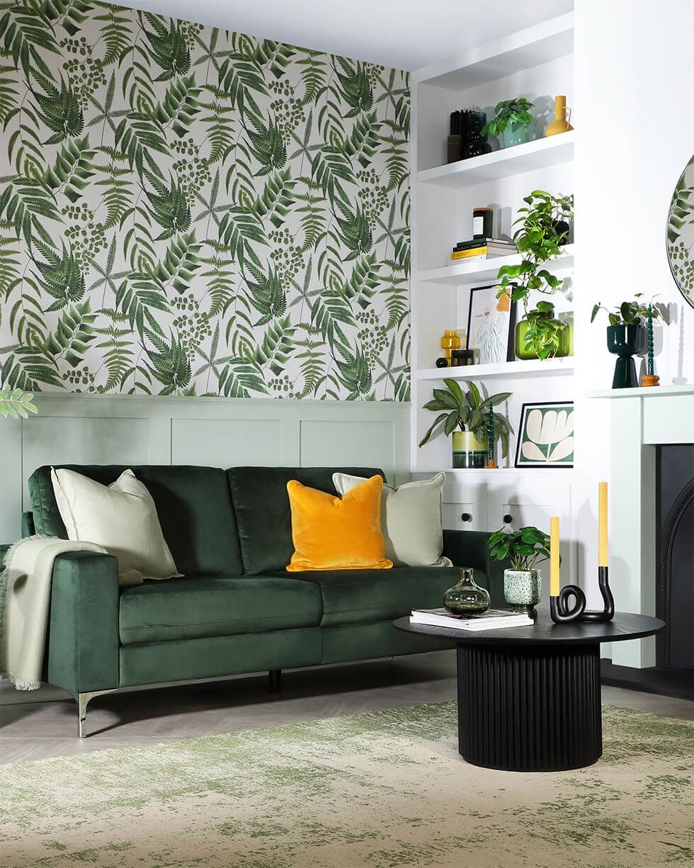 Tropicandi living room with bold leaf wallpaper and green colour palette