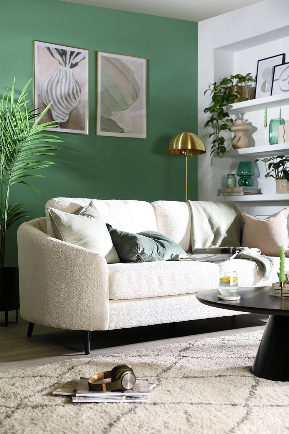 Tropicandi living room with sage green walls and Scandi style sofa