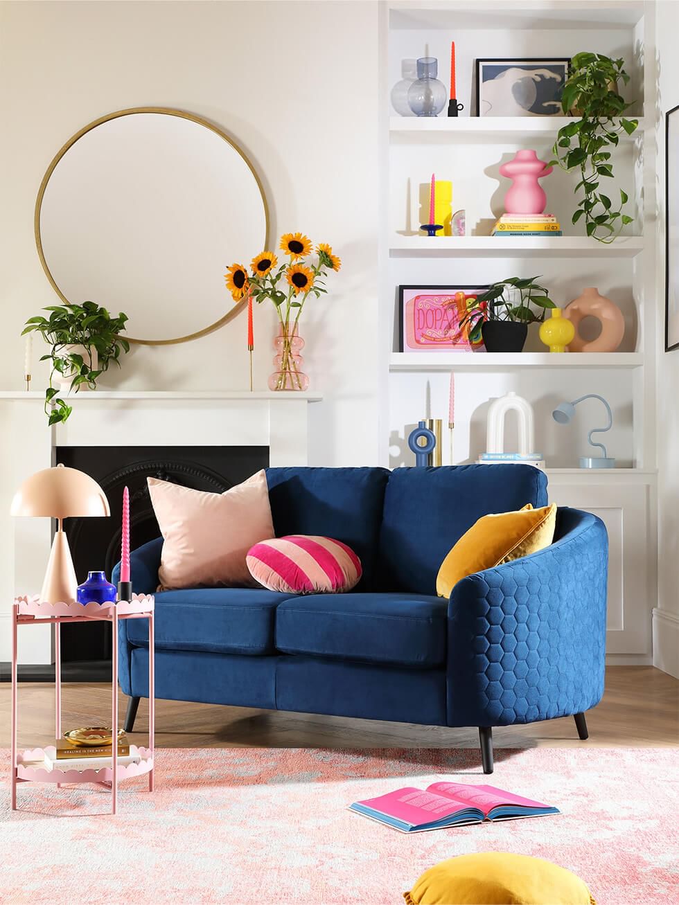 Dopamine decor living room with blue velvet sofa and pink accents
