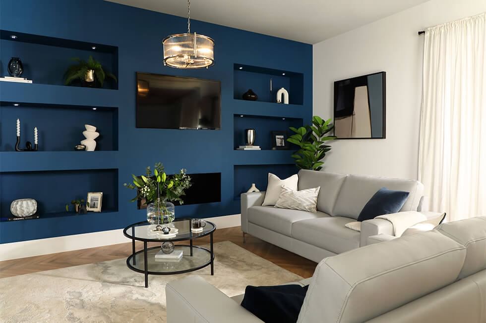 Modern living room with a grey sofa and a navy media wall