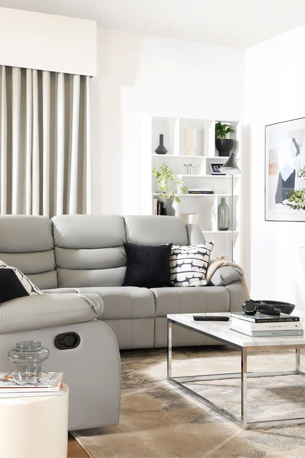 Contemporary living room with a light grey recliner sofa and neutral accents